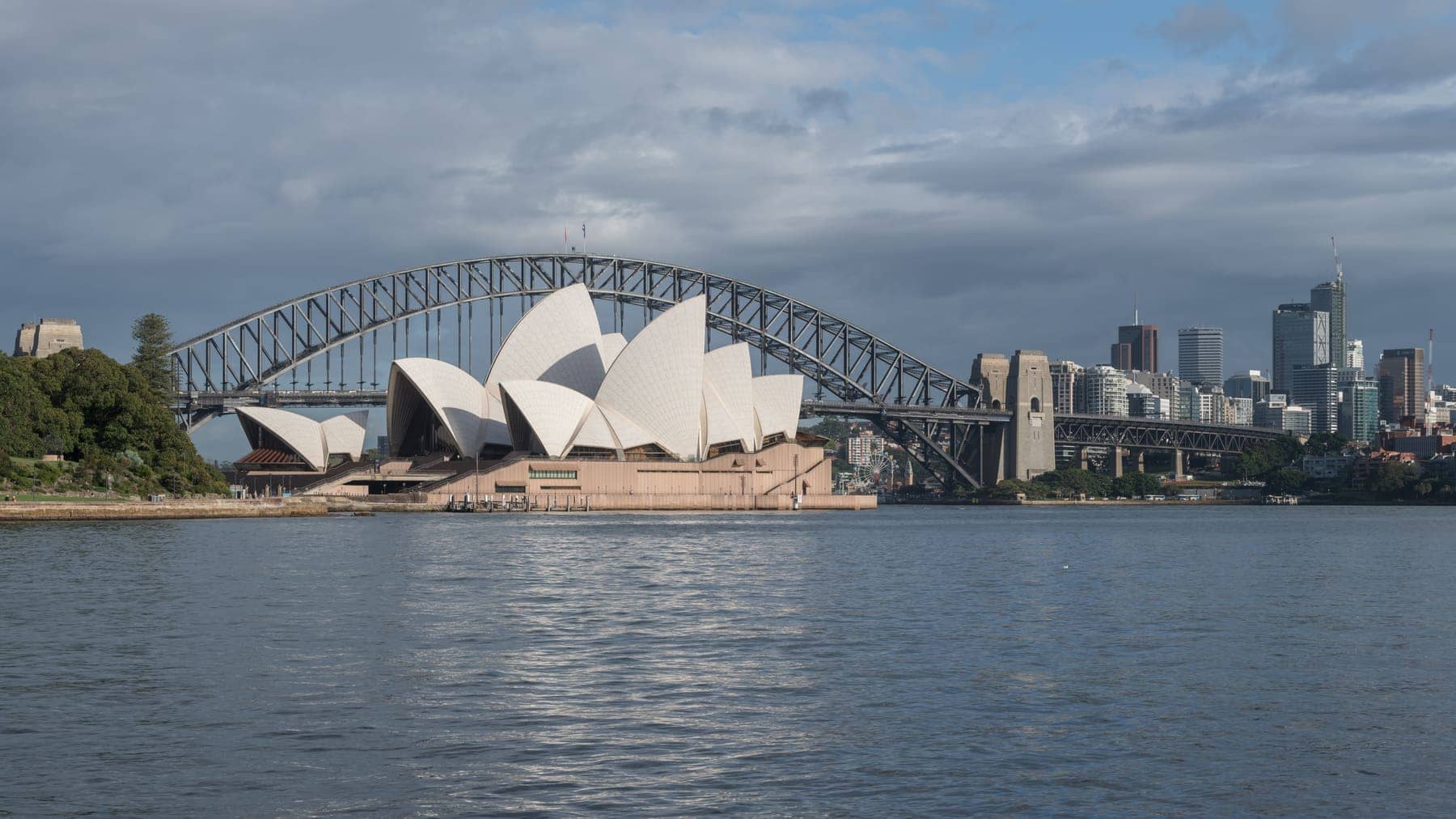 Sydney Opera House and the Sydney Harbour Bridge across the water, with the city skyline to the right